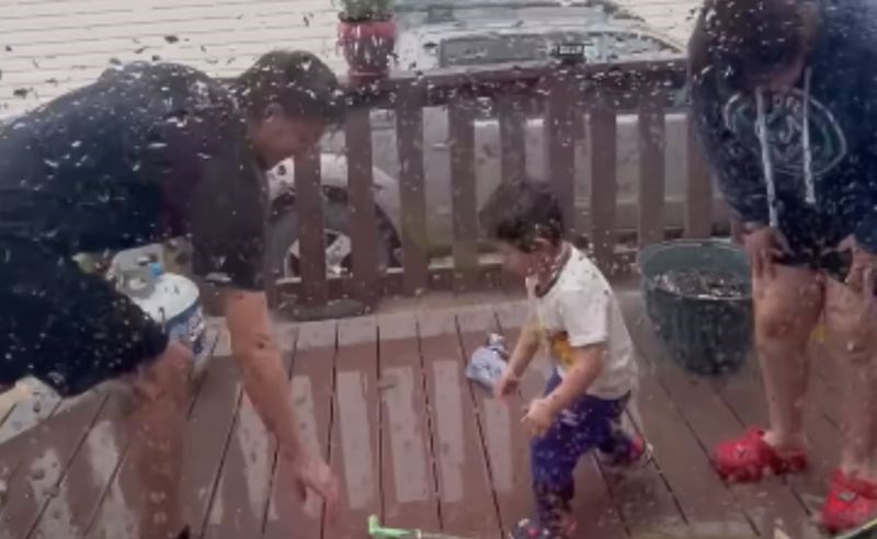 Obitelj se prskala vodom na trijemu, snimka je viralni hit zbog načina na koji je sin obranio mamu