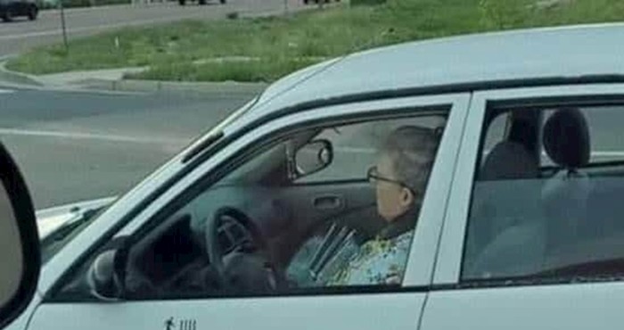 Ova starija žena na vratima svog auta ima naljepnice koje bi prolaznike mogle zabrinuti