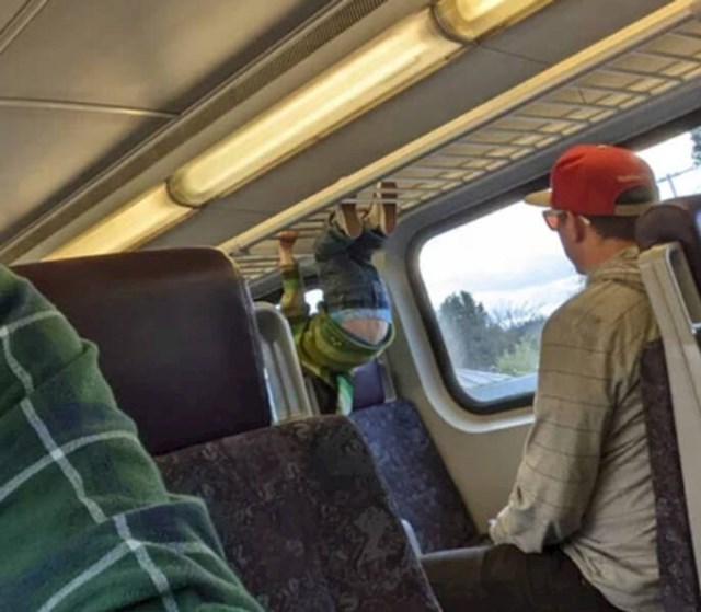 1. "Brat moga dečka dopušta djetetu da se penje po rešetkama za prtljagu u vlaku."
