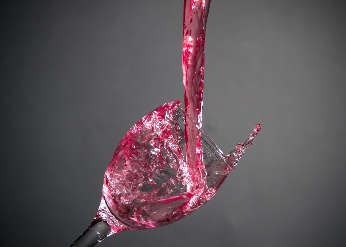 Water drops in wine glass / red